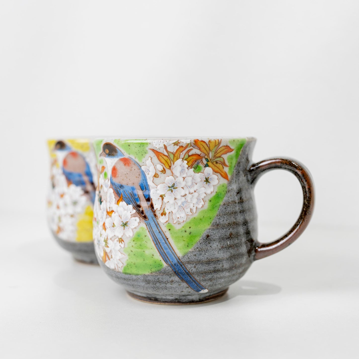 Side angle of bird motif across both mugs