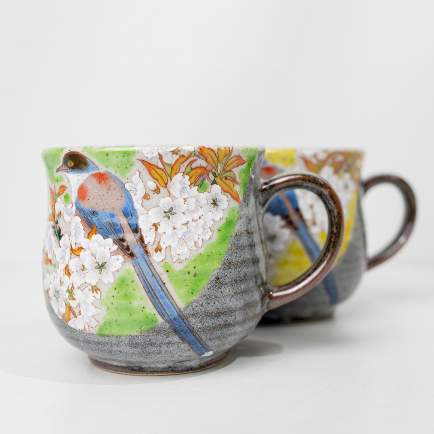 Front view of matching Kutani bird mug pair