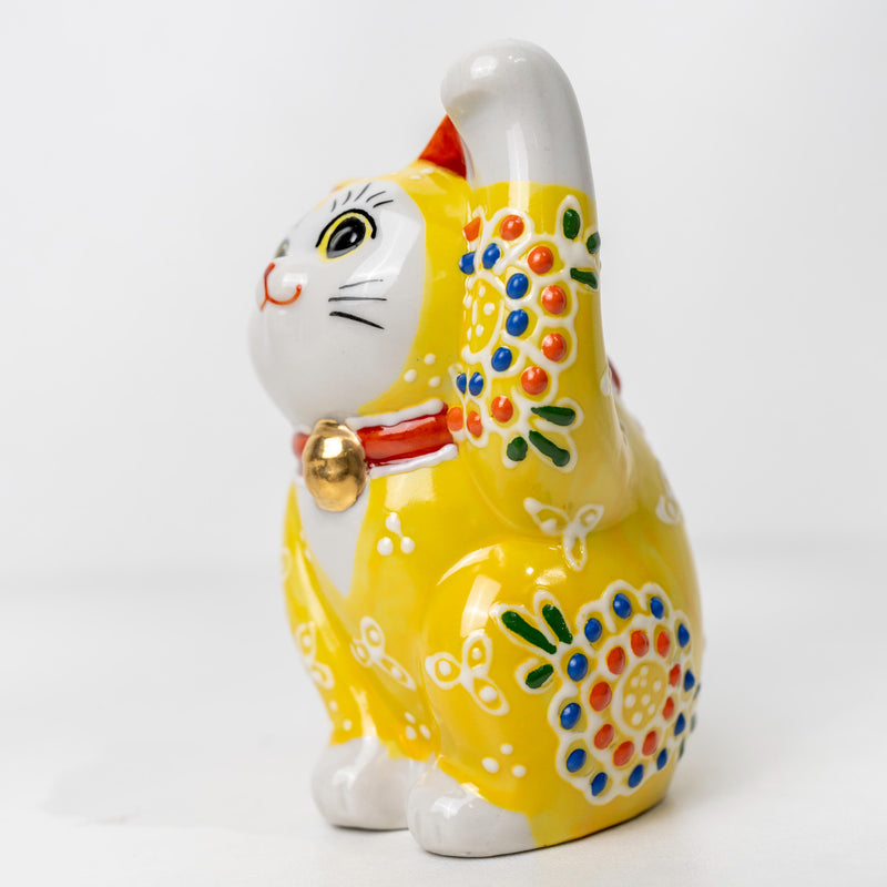 Front view of small yellow Maneki Neko statue
