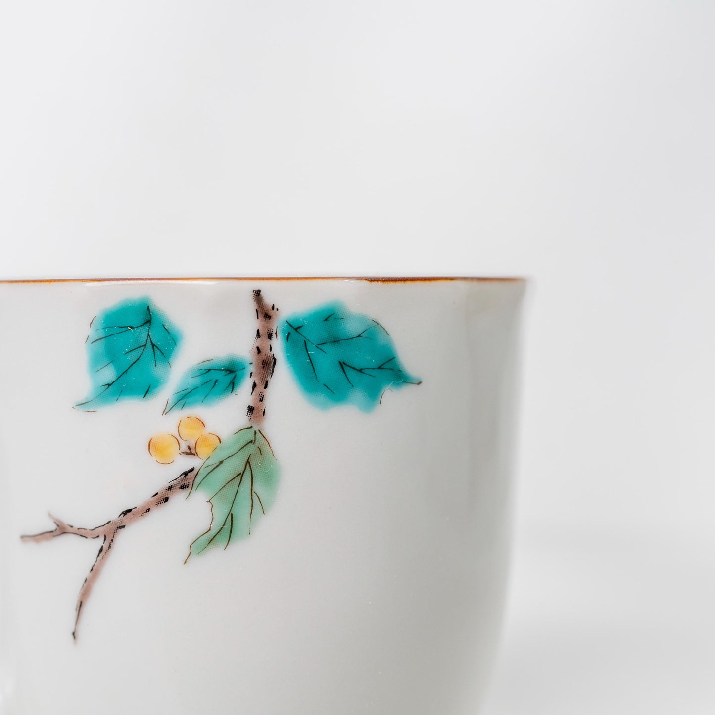 Side detail of hand-painted mejiro bird on porcelain mug