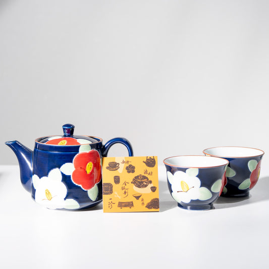 Angled view of kyusu teapot and yunomi cups with indigo camellia motif