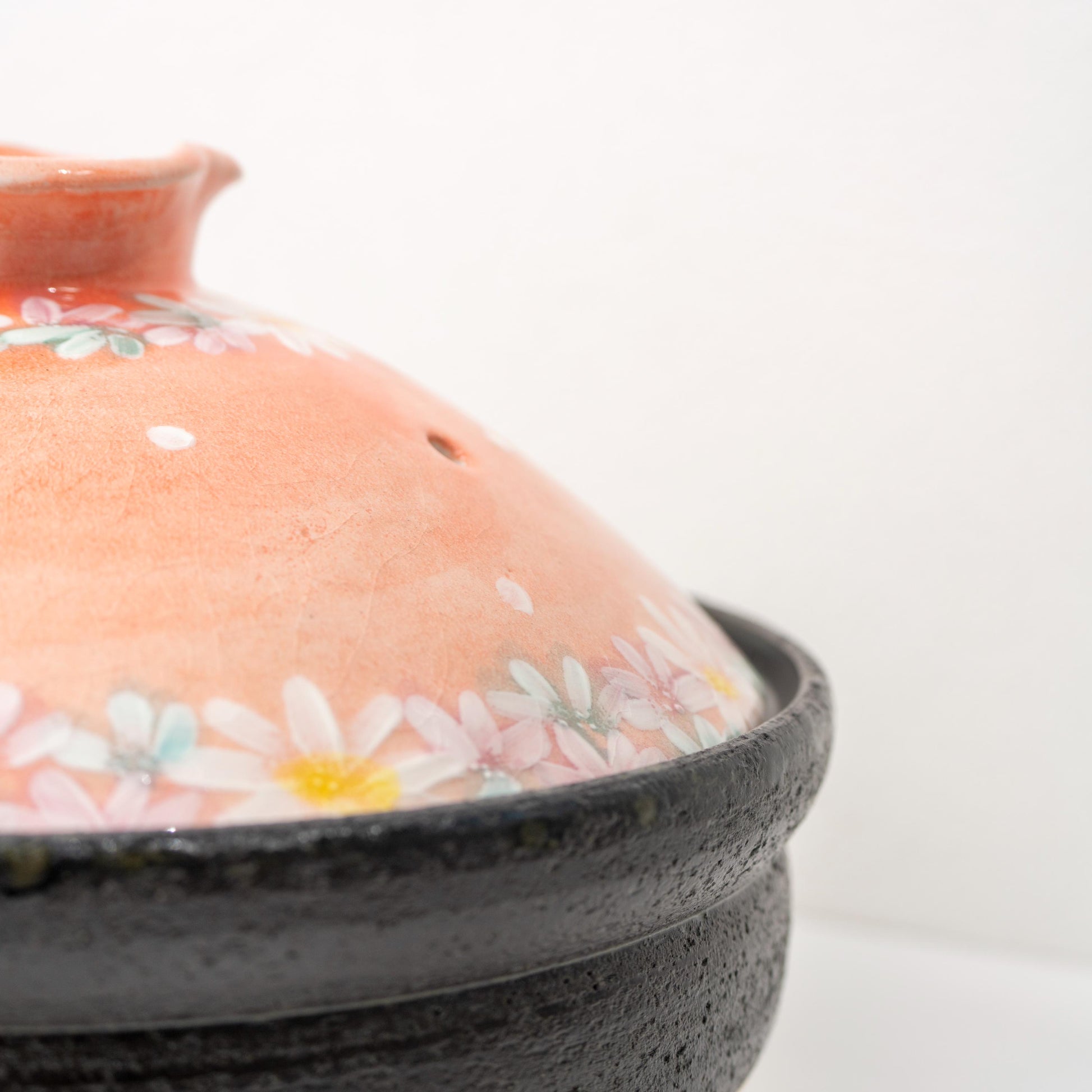 Top view of the donabe lid showing floral pattern