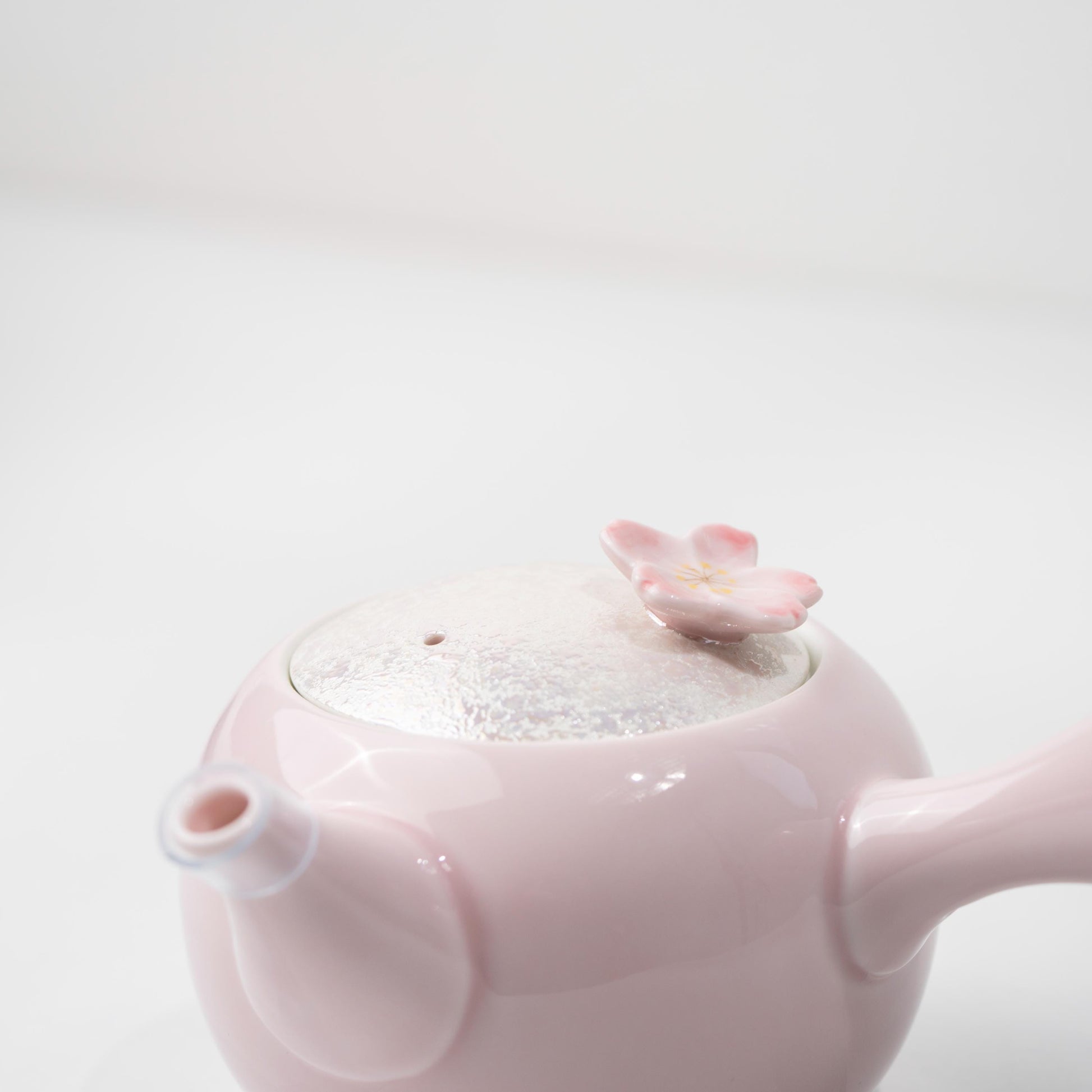Side view of Japanese kyusu teapot with petal-inspired handle