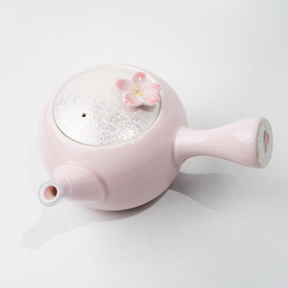 Side view of Japanese kyusu teapot with petal-inspired handle