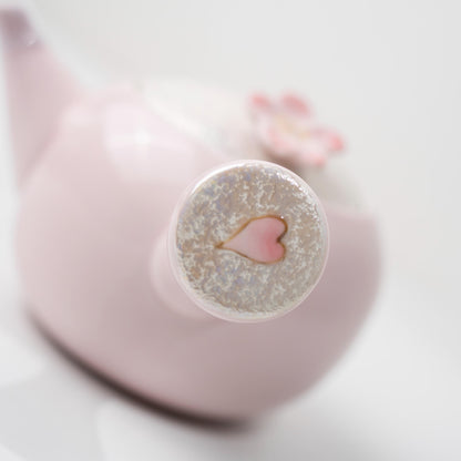 Top view of Arita kyusu teapot with cherry blossom lid detail
