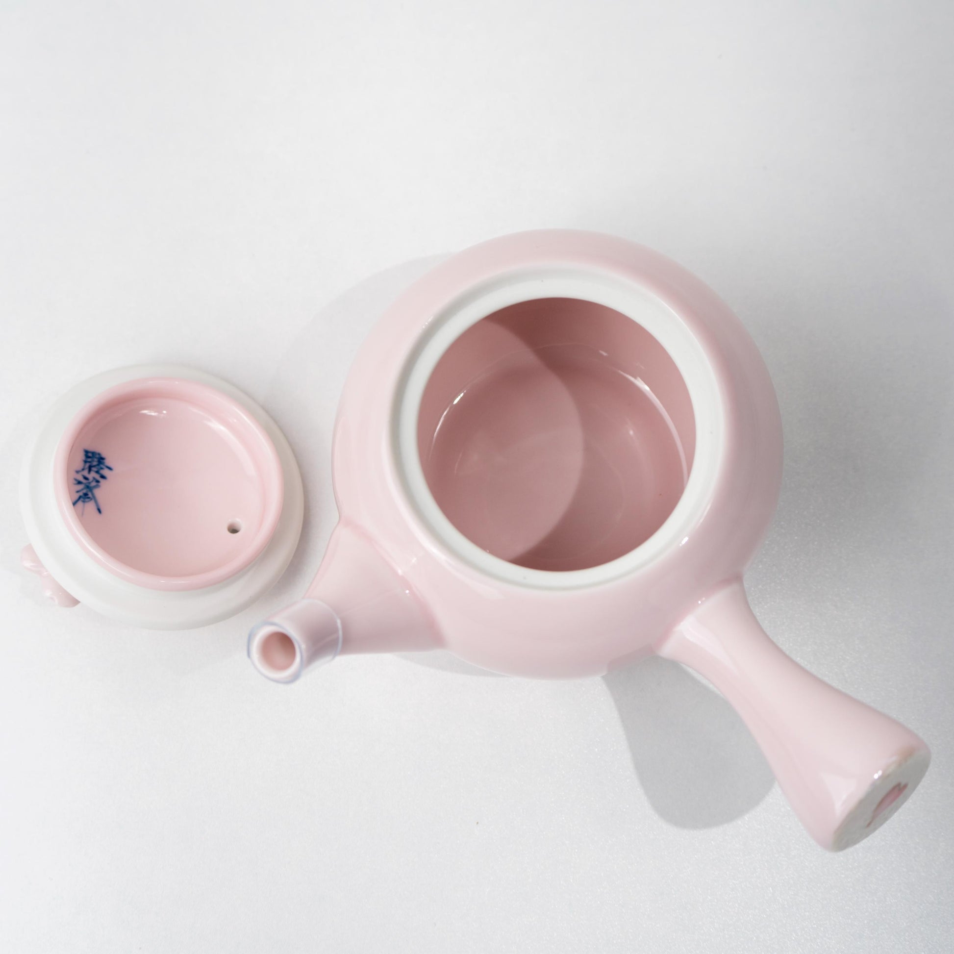 Top angled view of teapot opening and lid