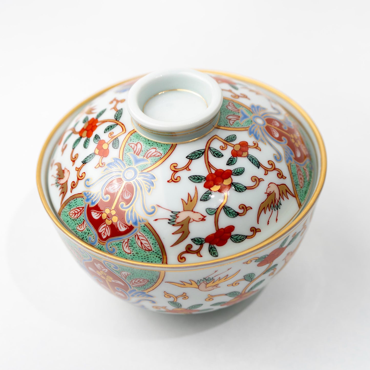 Three-quarter view of lidded porcelain rice bowl in Ko-Imari style