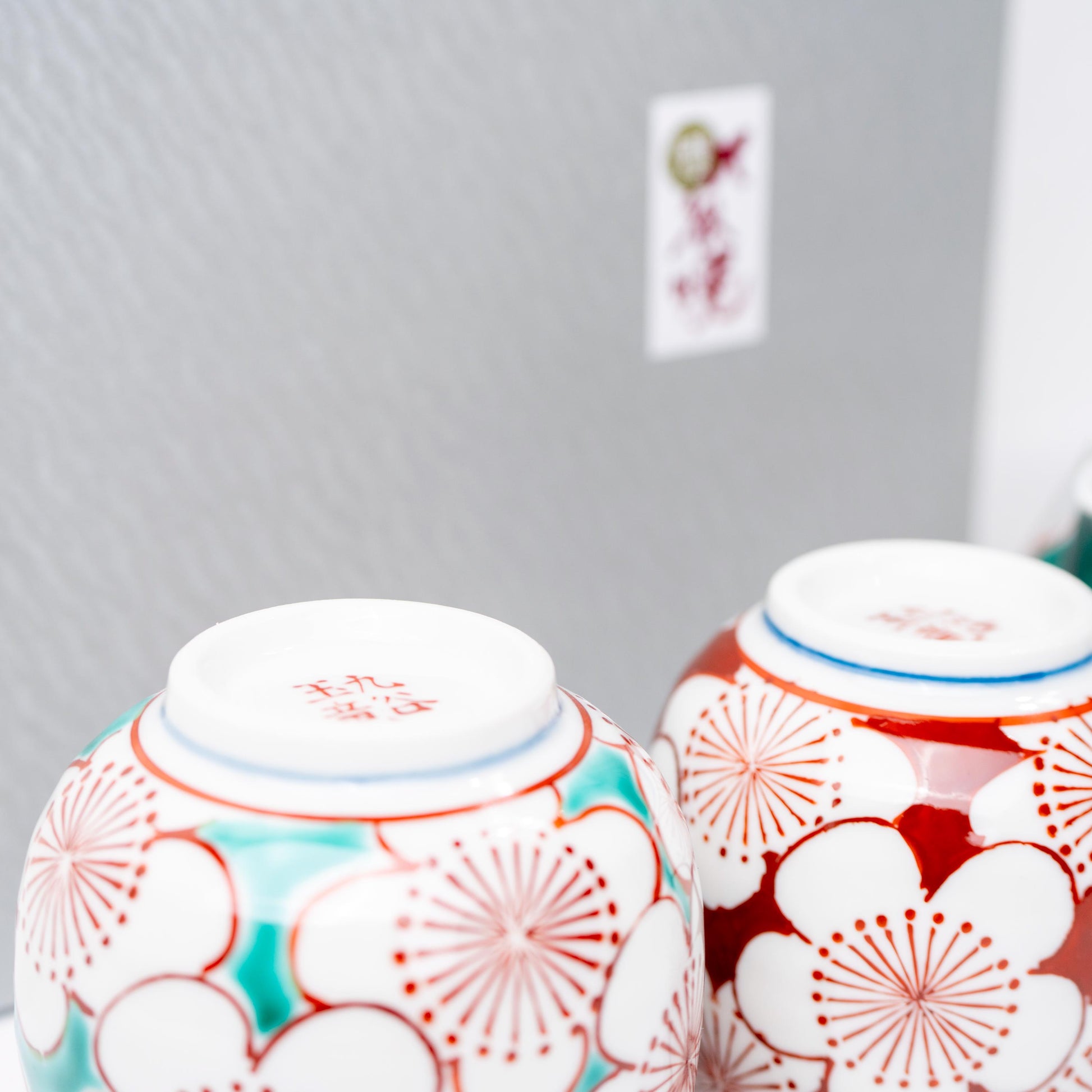 Side view of Kutani porcelain teapot with plum blossom motif