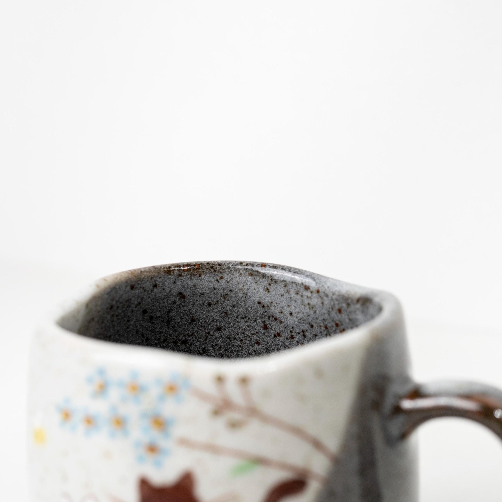 Top view of Japanese ceramic cat mug showing dark interior glaze