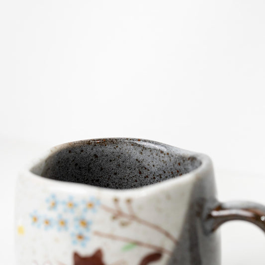 Top view of Japanese ceramic cat mug showing dark interior glaze