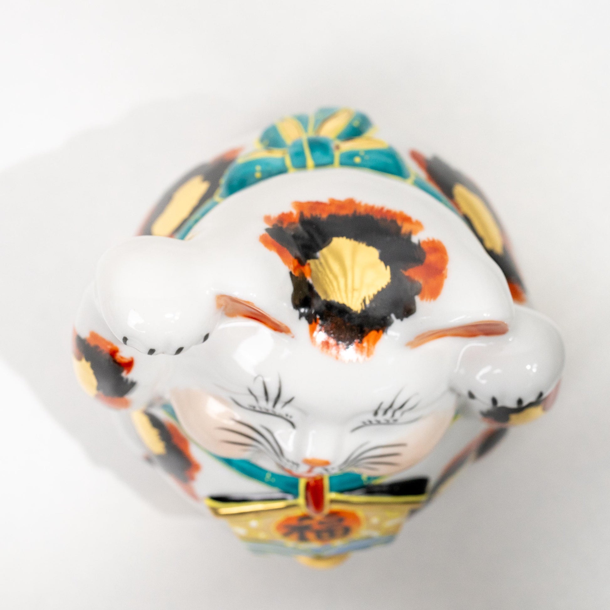 Underside of Kutani ceramic lucky cat showing base opening
