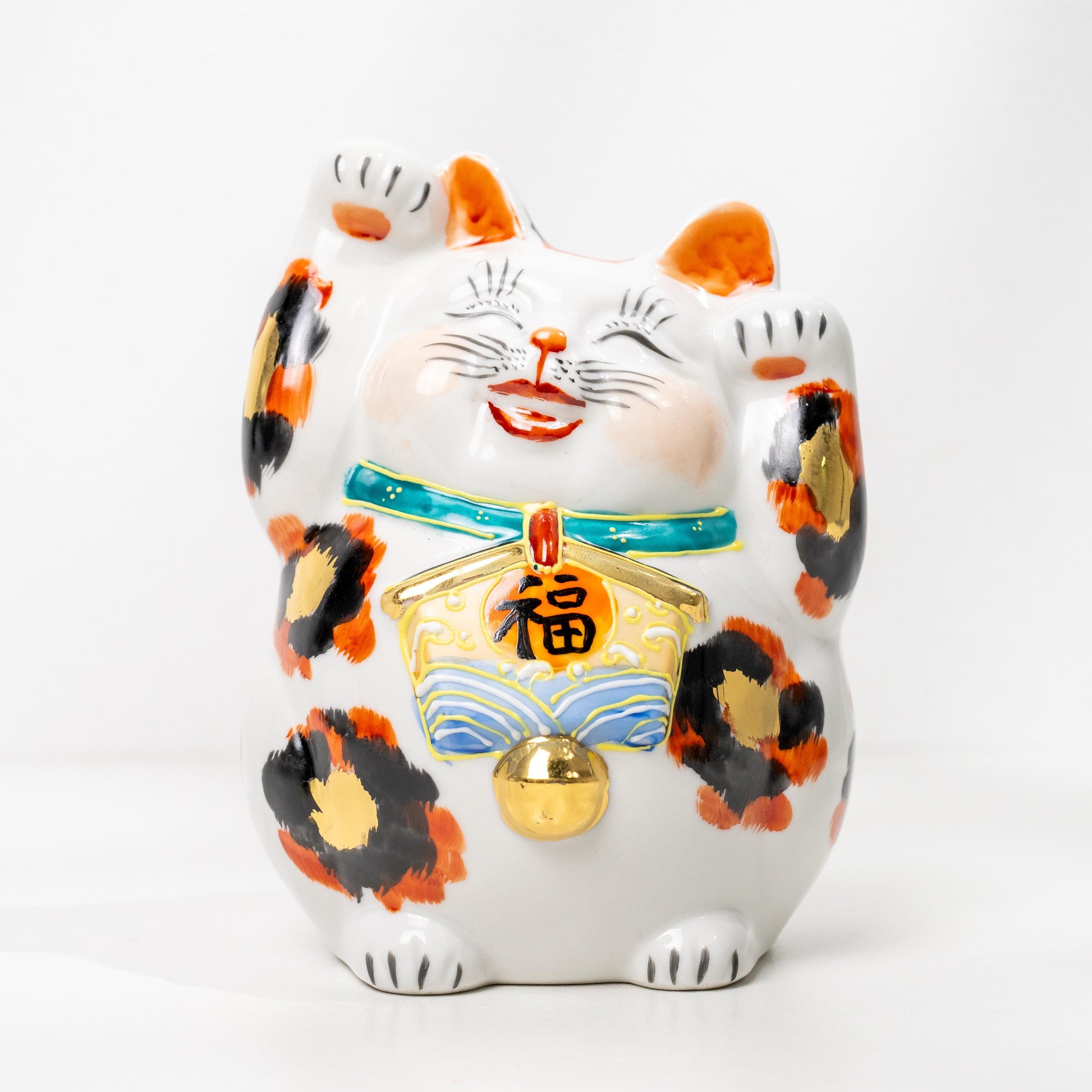 Three-quarter view of gold calico lucky cat statue