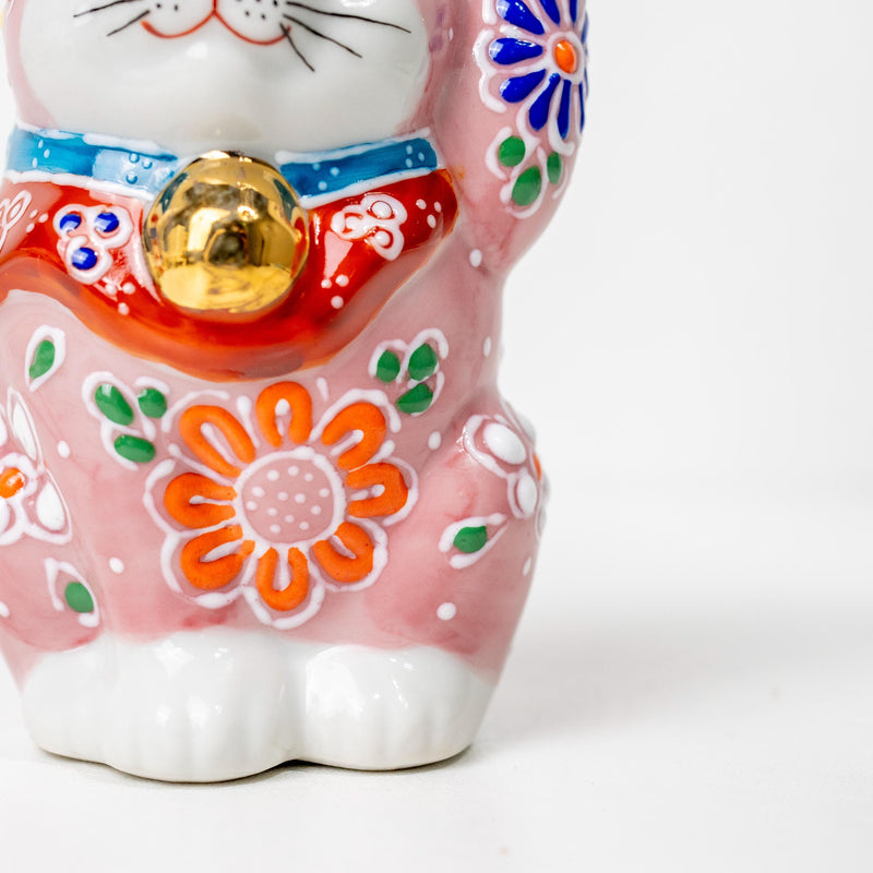 Front detail of floral kutani-style lucky cat figurine