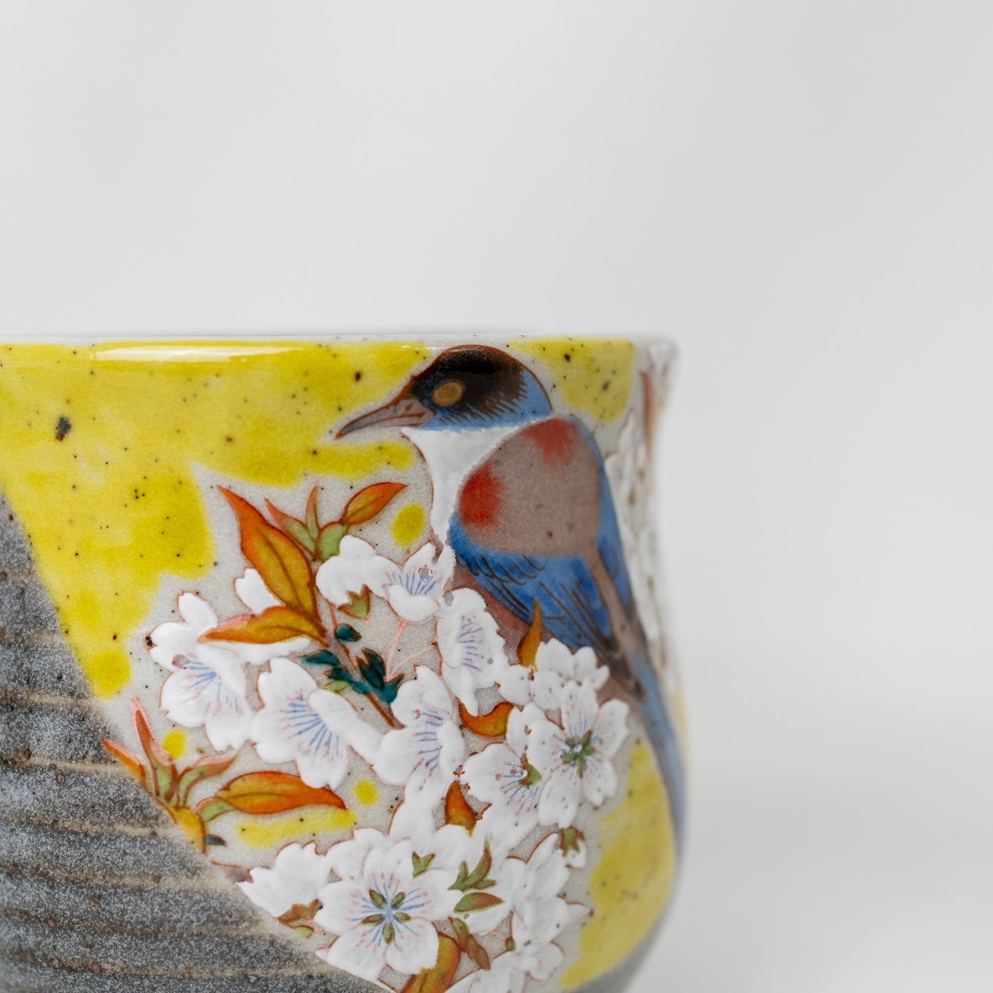 Side view of yellow Kutani bird mug