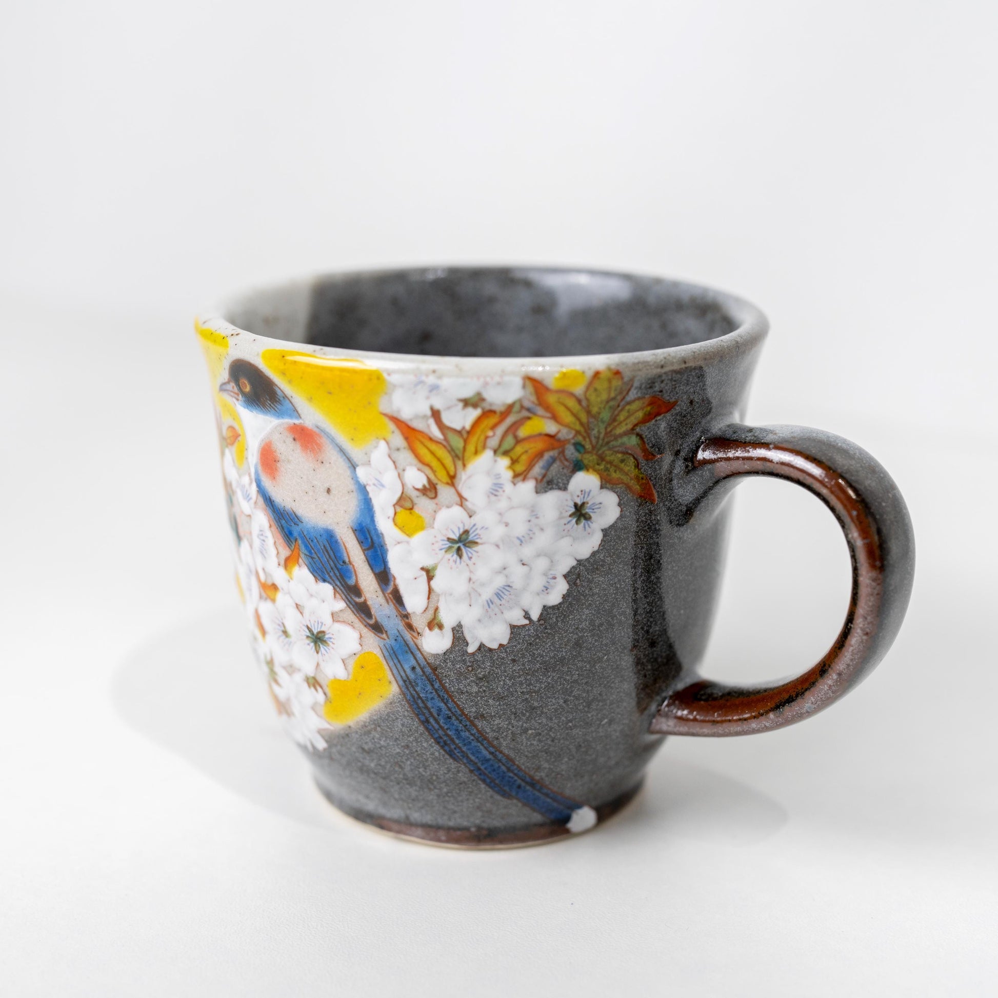 Side view of hand-painted sakura bird mug