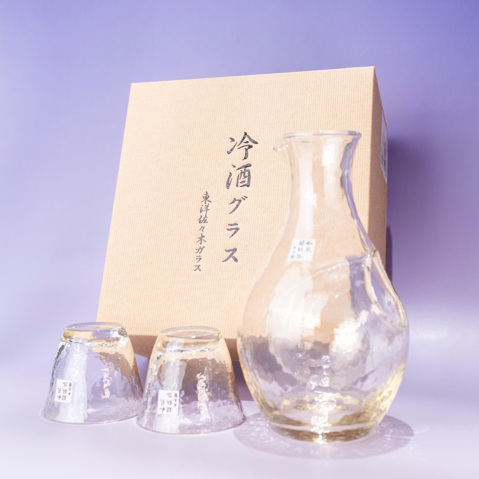 Amber glass sake set with ice pocket carafe and two cups beside gift box