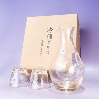 Amber glass sake set with ice pocket carafe and two cups beside gift box