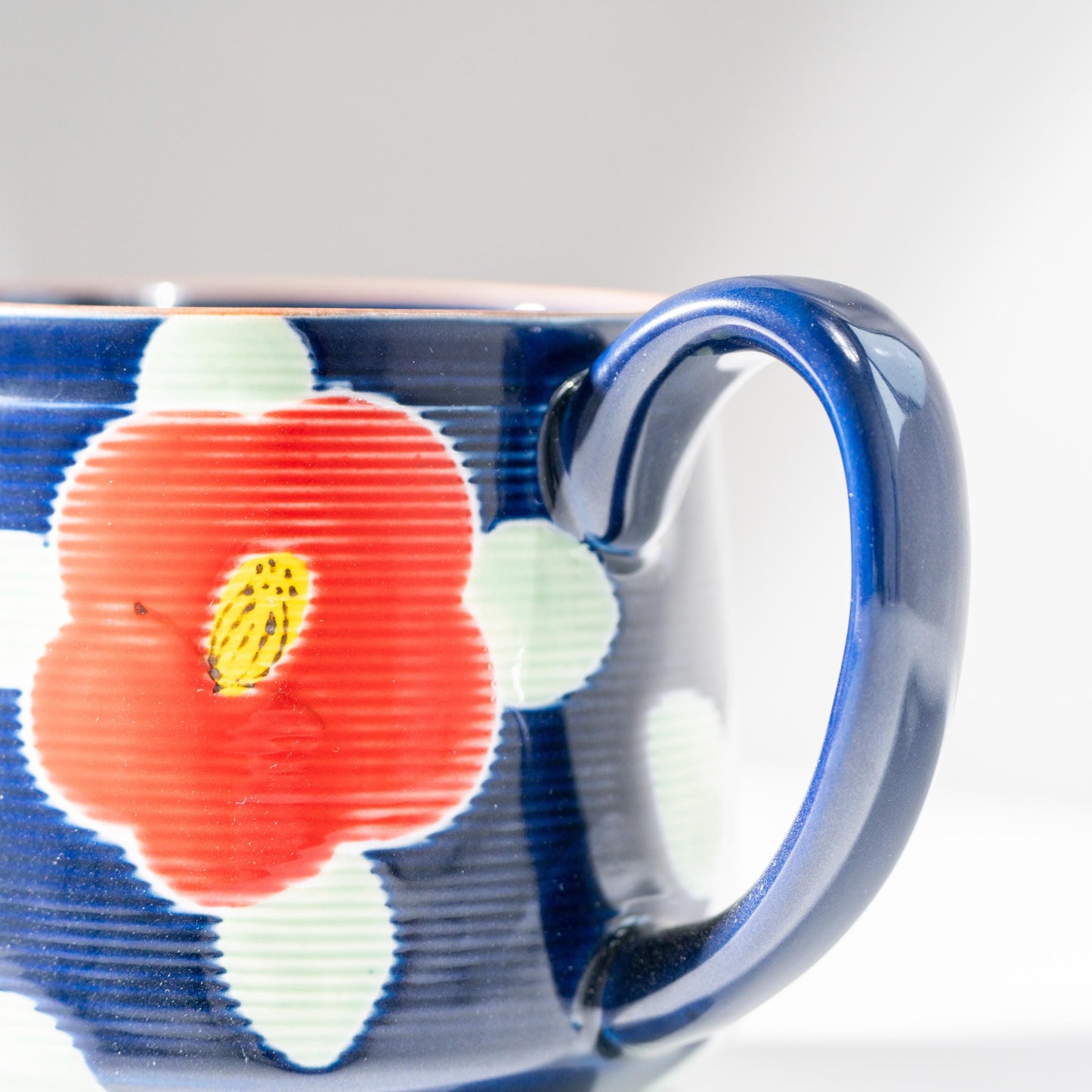 Detail of hand-painted camellia motif on Arita porcelain teapot