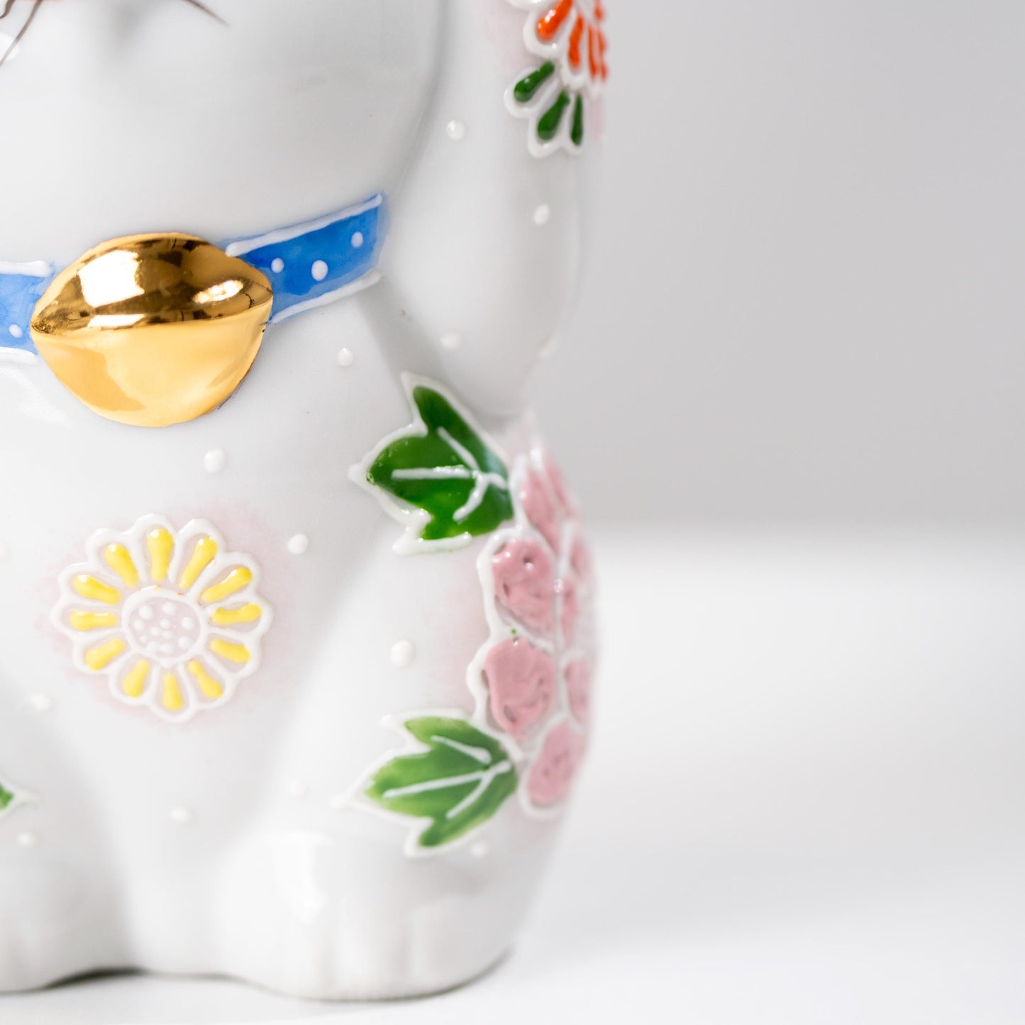 Three-quarter view of Kutani Maneki Neko figurine