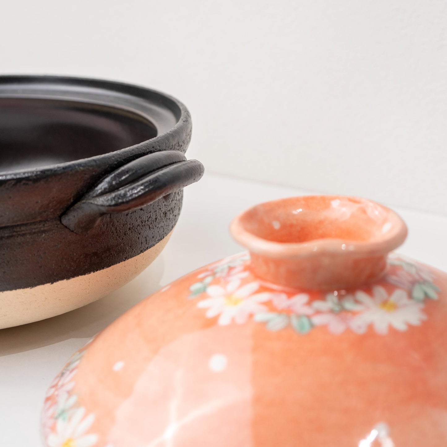 Close-up of hand-painted floral detail on the donabe lid