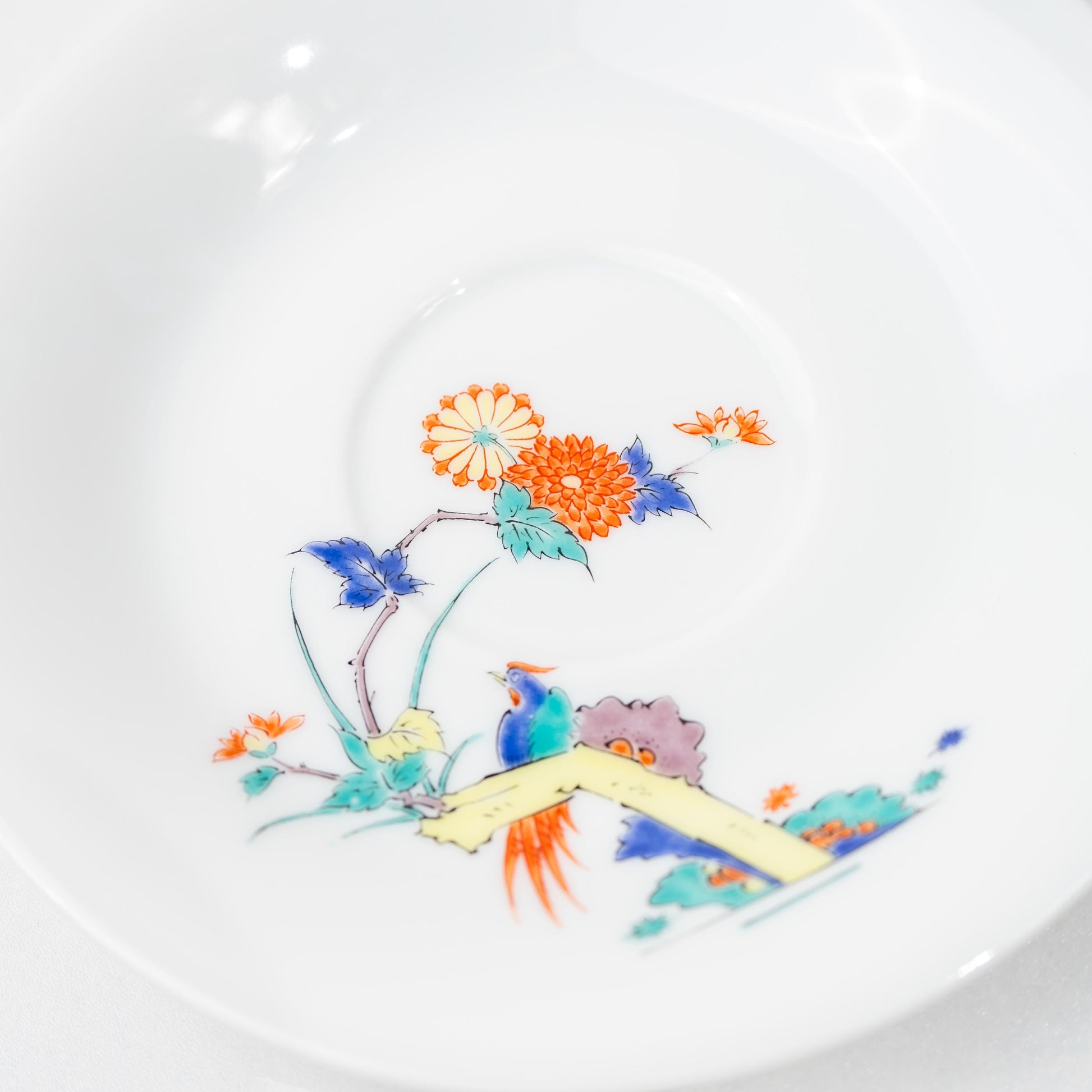 Close-up of bird and floral motif on a hand-painted Arita cup