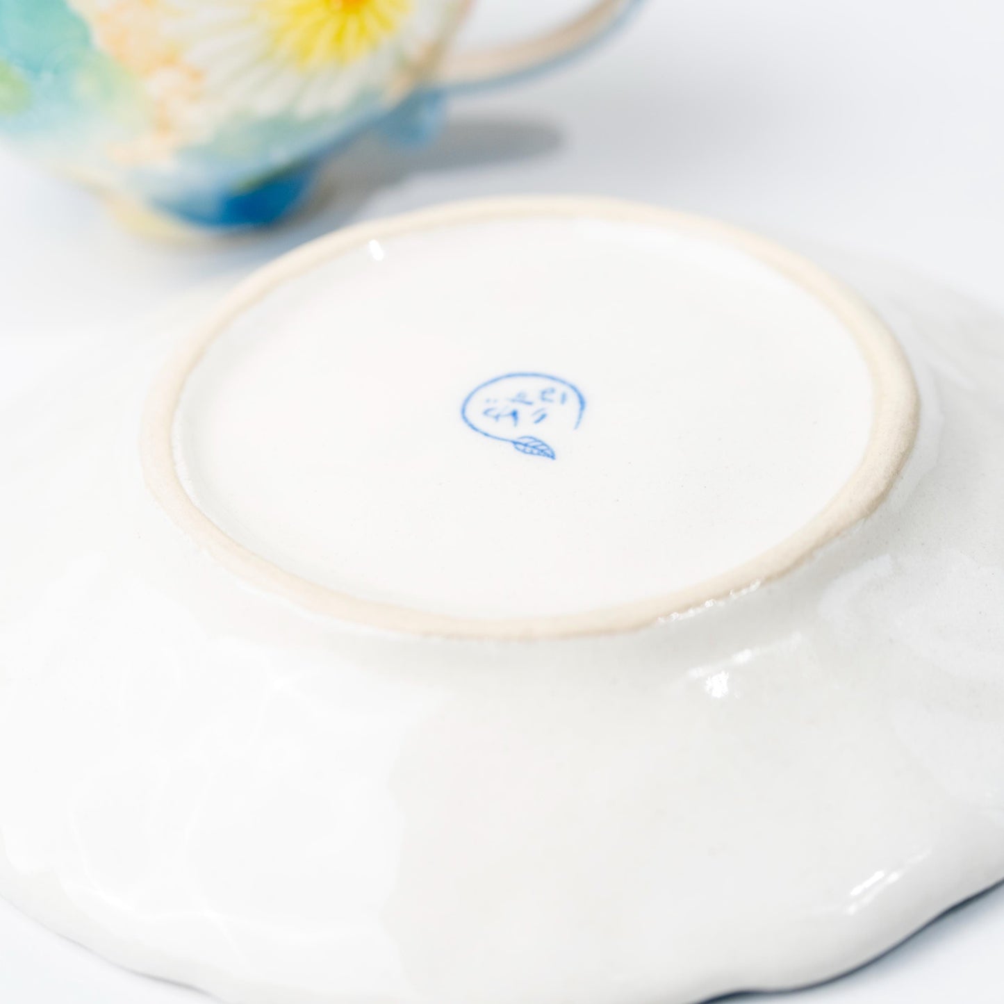 Underside of ceramic cup and saucer showing base