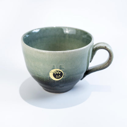 Front view of Shigaraki mug and saucer on white background