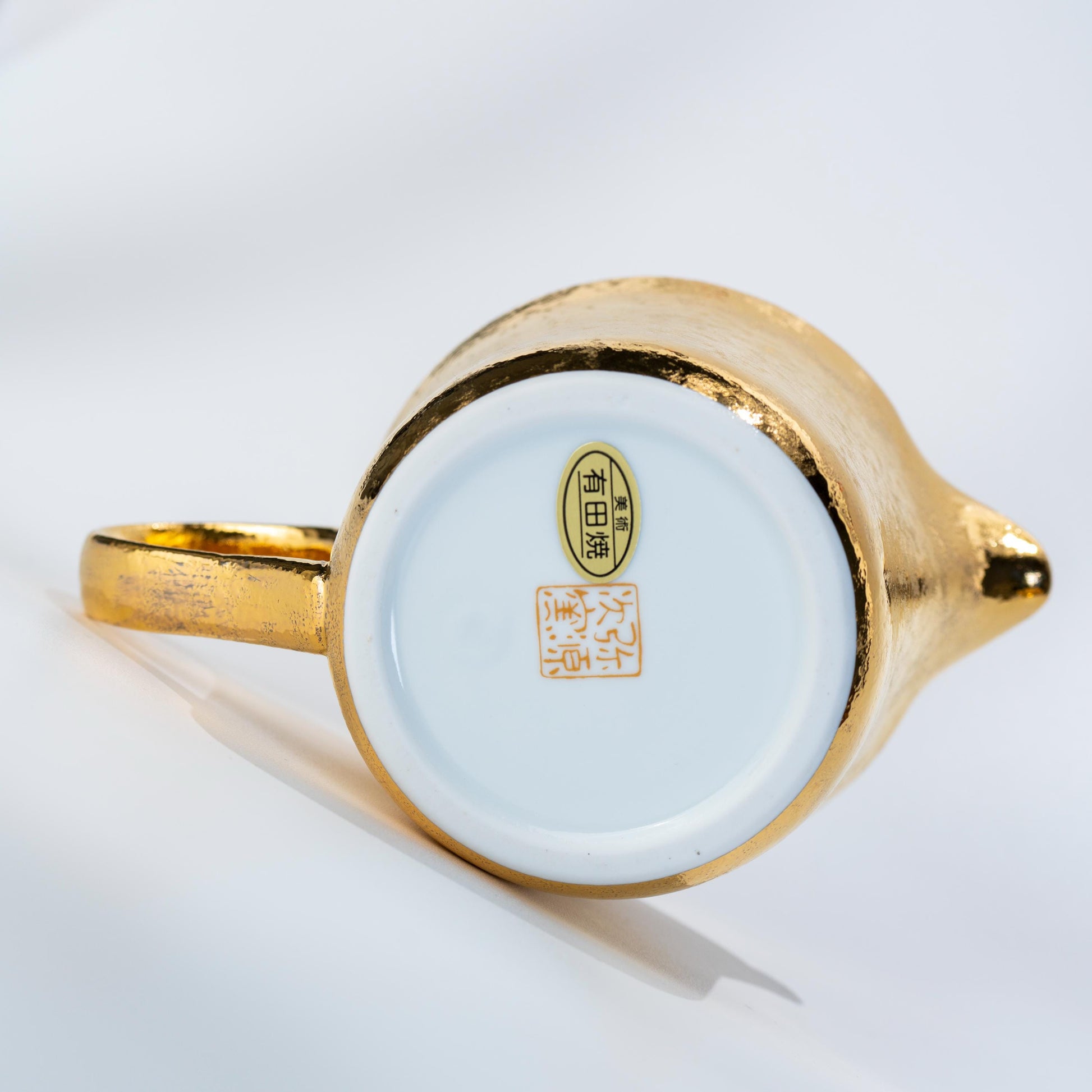 Underside of porcelain tea cup showing base and foot ring