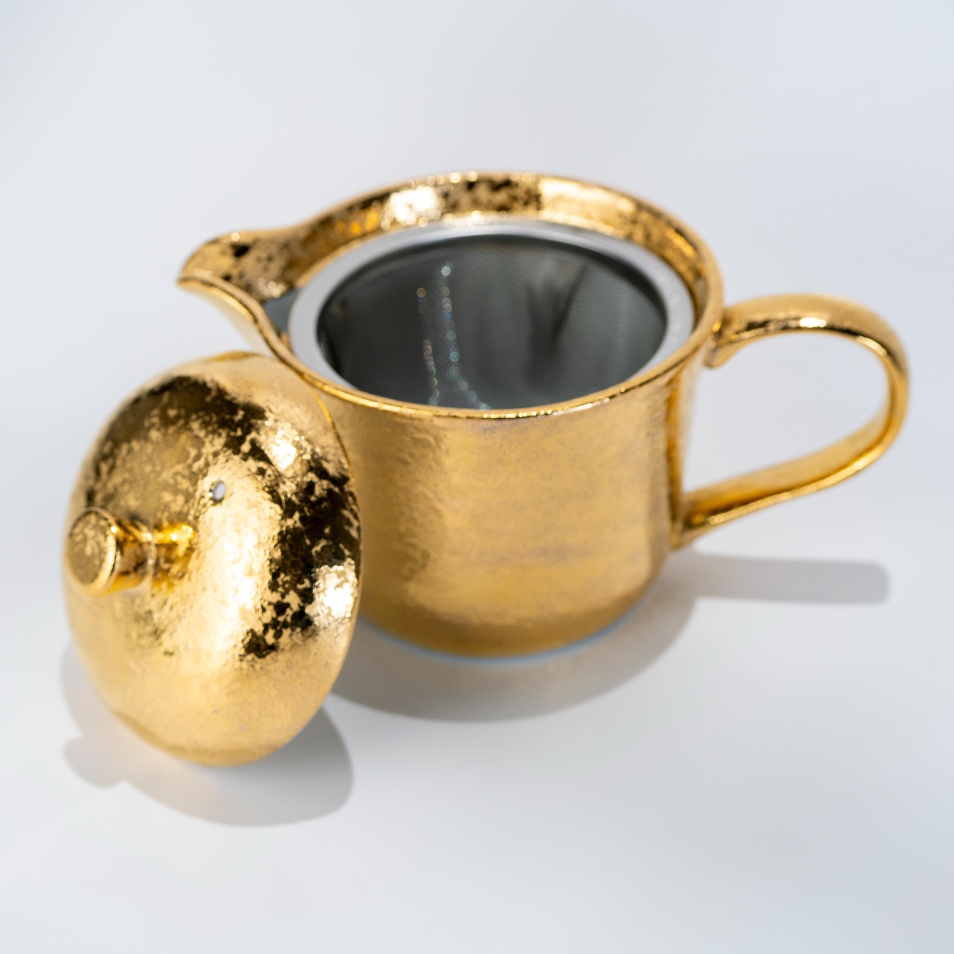 Close-up of Arita teapot spout and handle in gold glaze