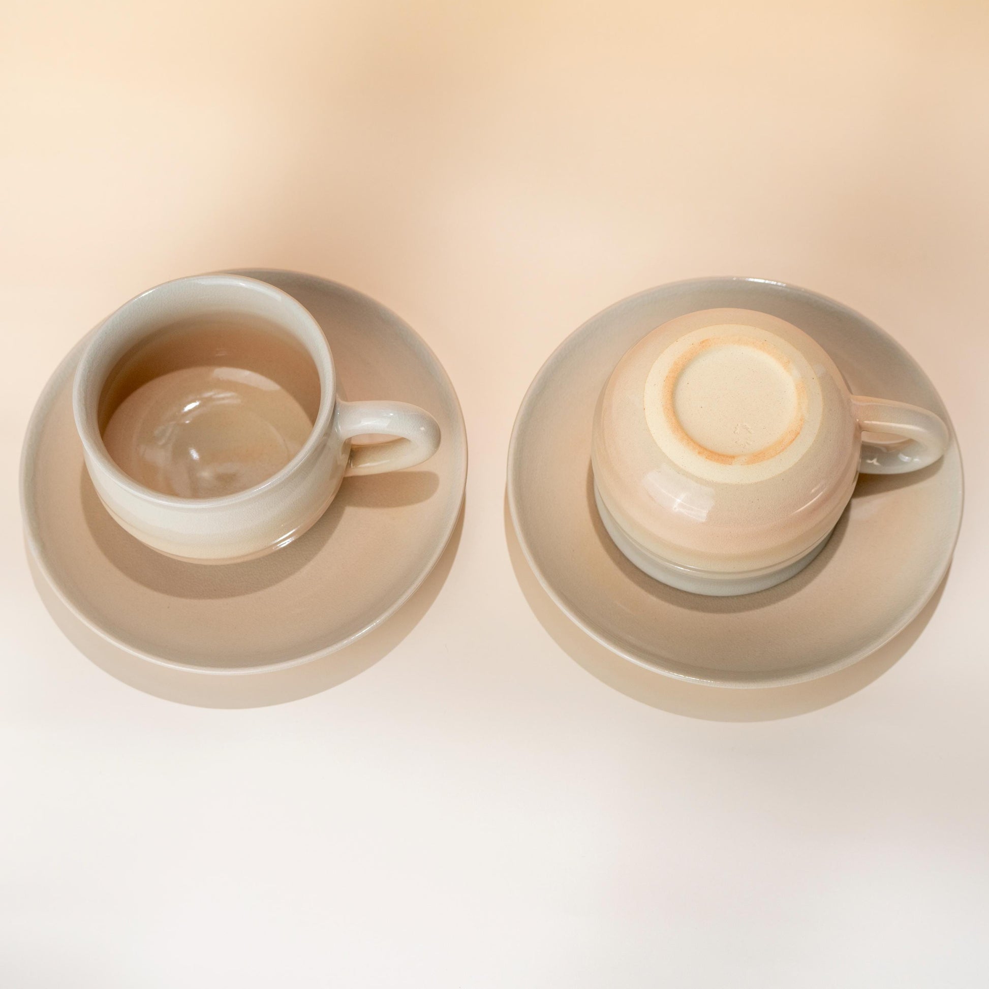 Two handmade Hagi yaki coffee cup and saucer sets in a soft blush glaze