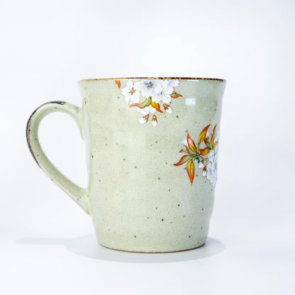 Single Kutani ware mug with cherry blossom and bird motif on a light background