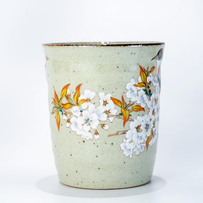 Side view of Kutani cherry blossom bird mug in hand-painted Japanese ceramic