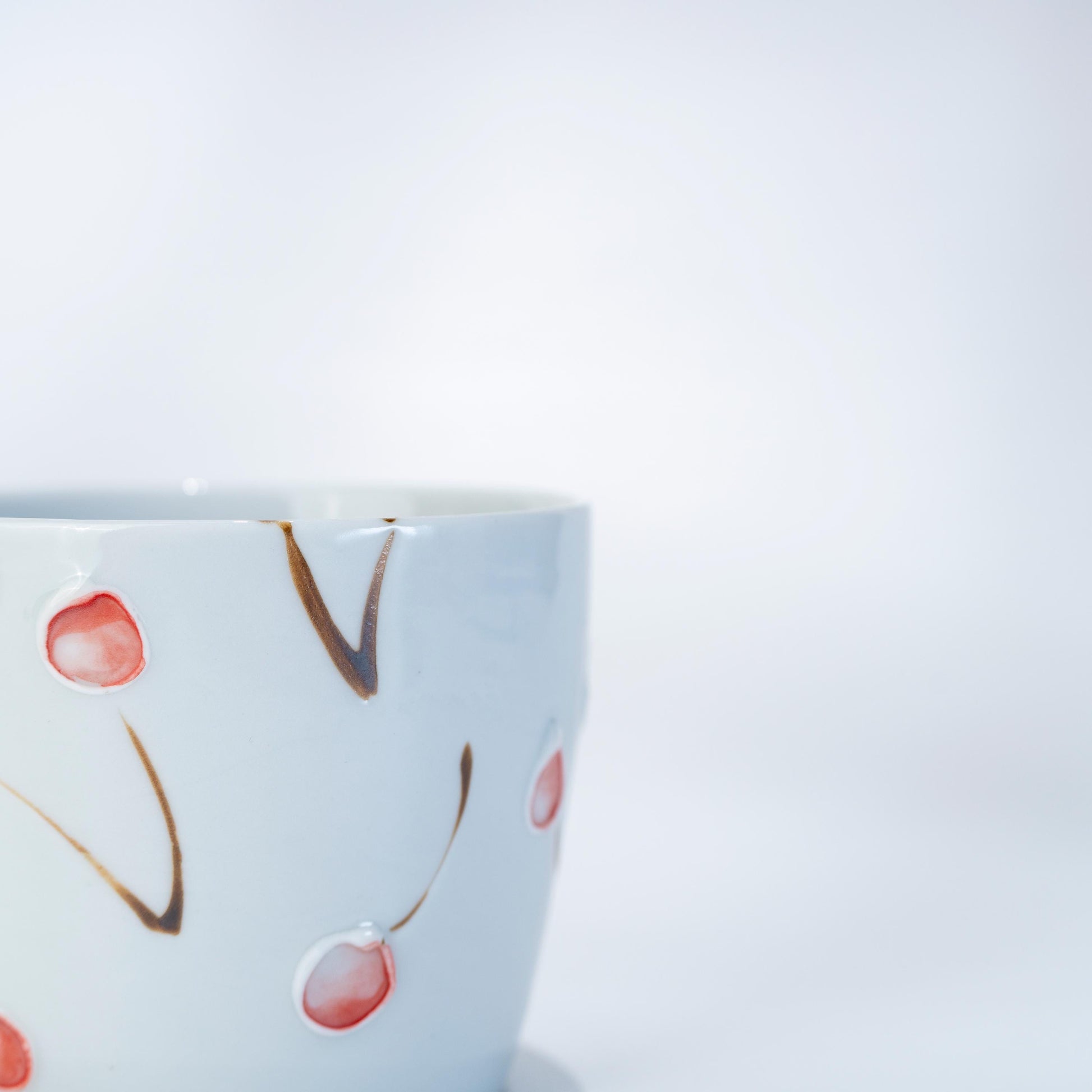 Close-up of the cherry motif on an Arita Hasami porcelain tea cup
