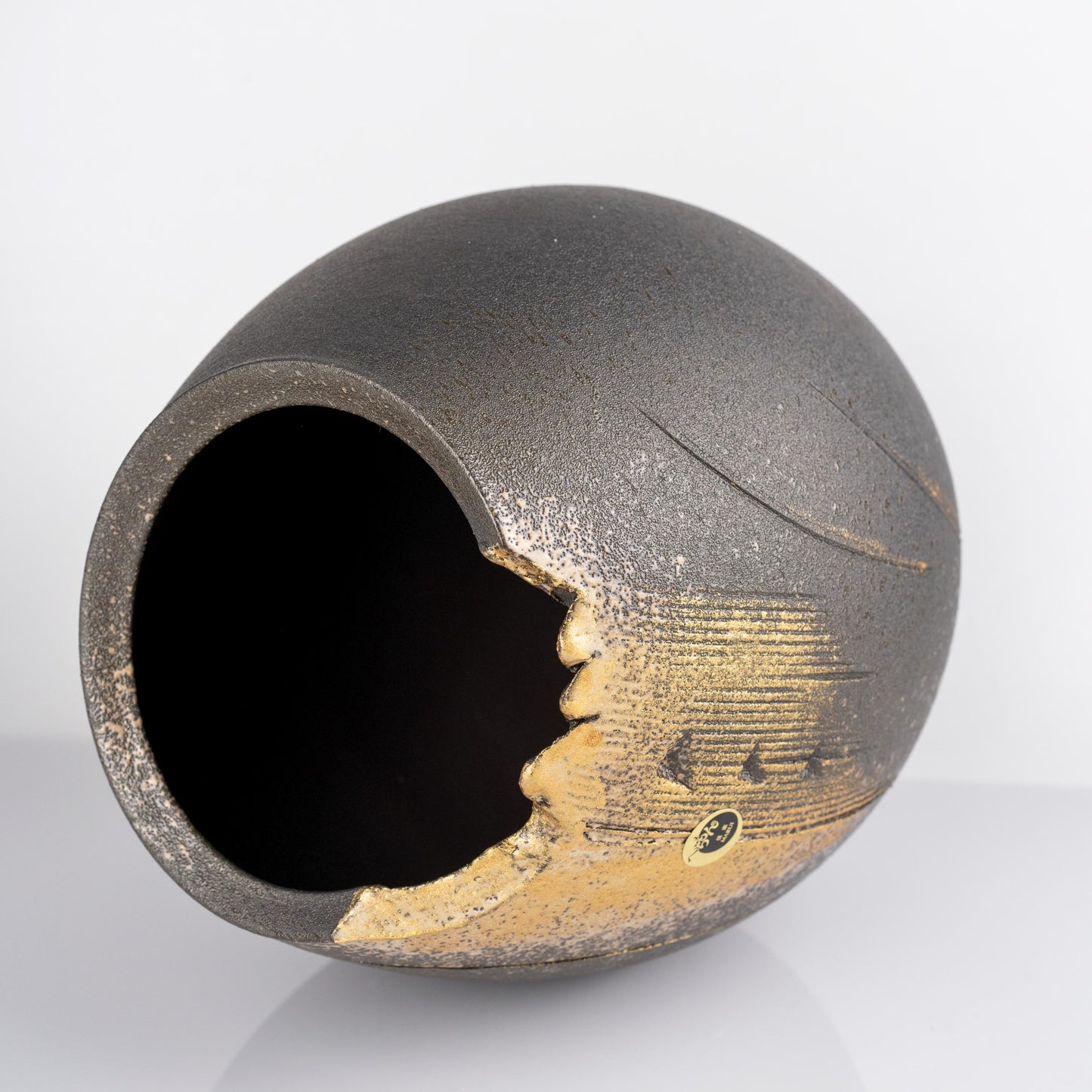 Close-up of the black and gold glaze on a handmade Shigaraki vase