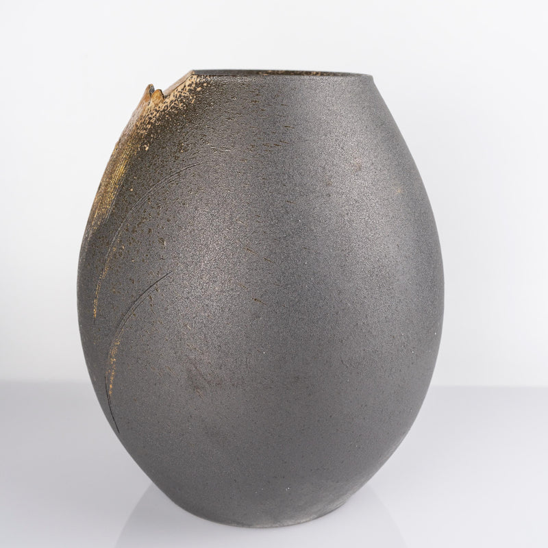 Front angled view of Shigaraki black gold vase with rounded form