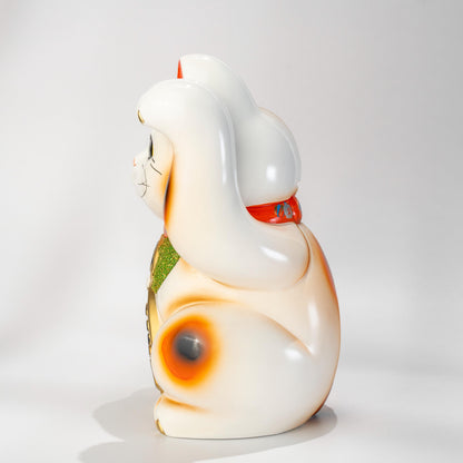 Side view of white Tokoname Maneki Neko figurine in ceramic
