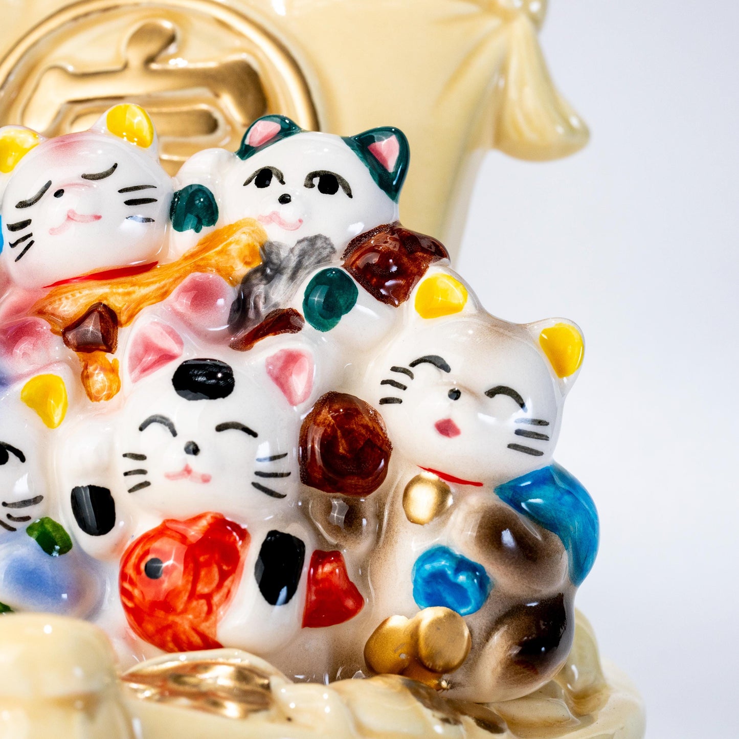 Close-up of painted lucky cat details on Seto ware figure