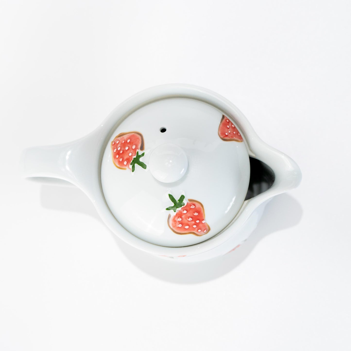 Top detail of lid with raised strawberry design