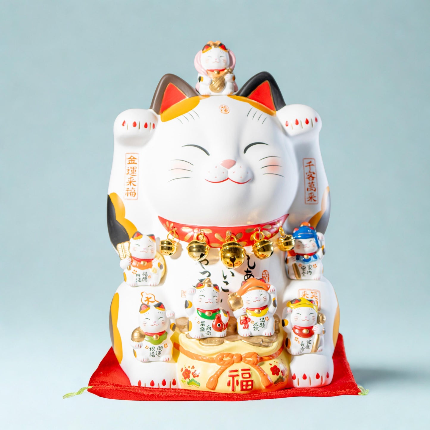 Yakushi Kiln Maneki Neko with Seven Lucky Gods and raised left paw