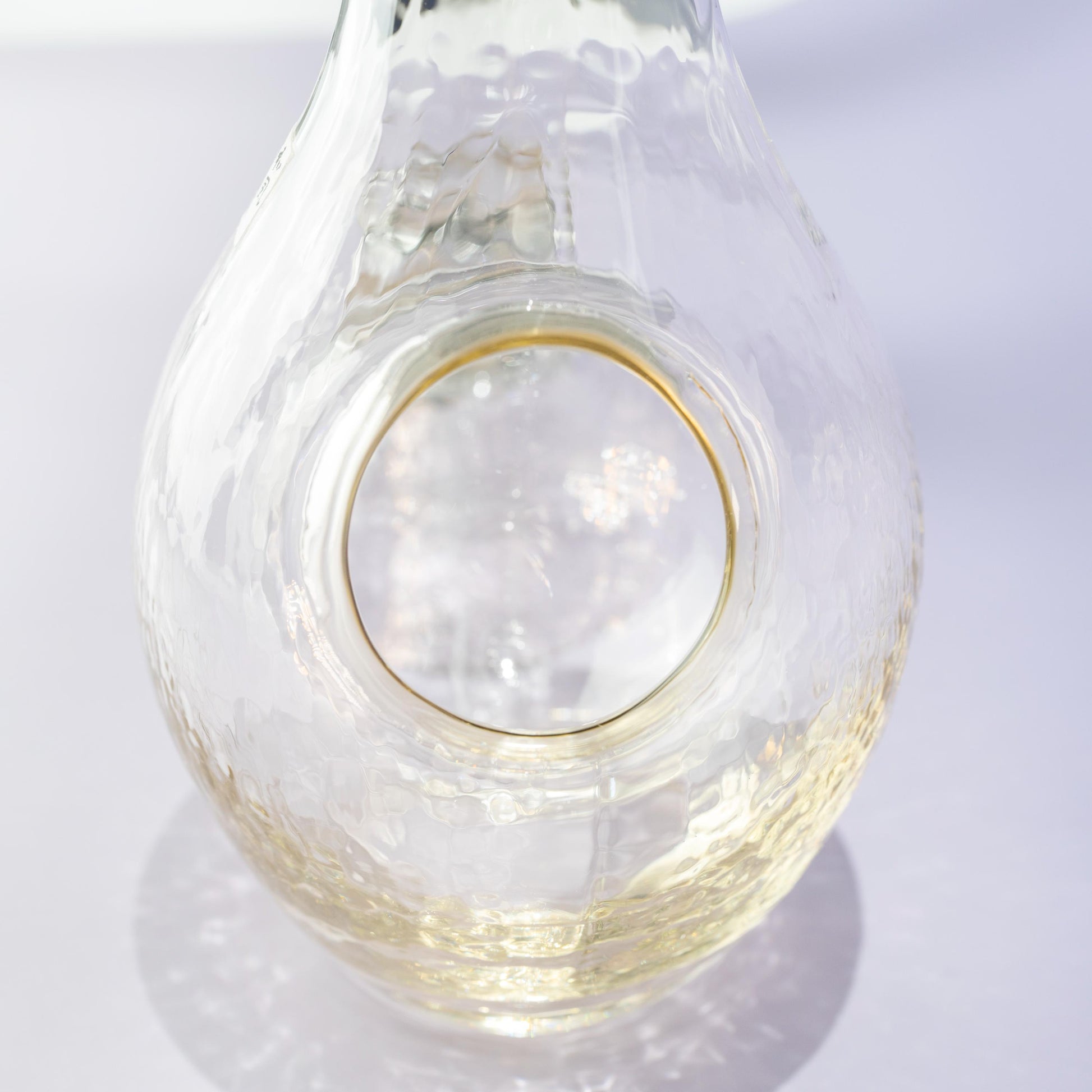 Angled view of amber glass carafe for chilled sake
