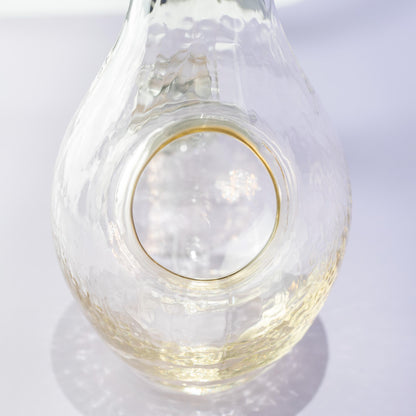 Angled view of amber glass carafe for chilled sake