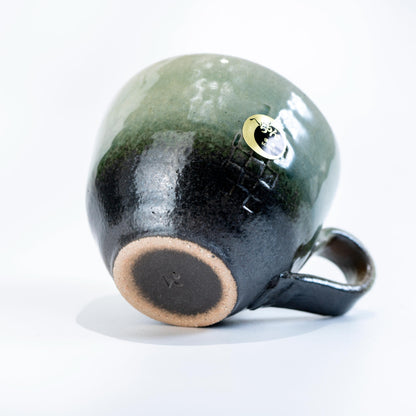 Back angle of olive green ceramic coffee cup