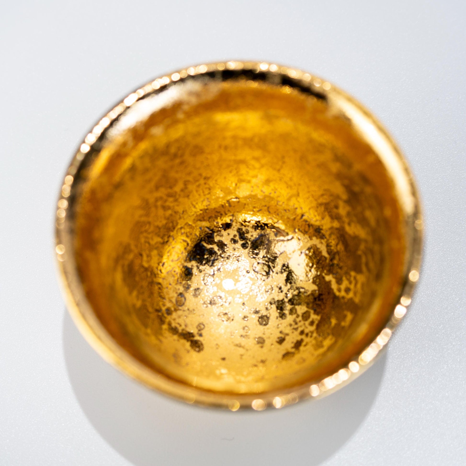 Top view of two gold glazed porcelain tea cups