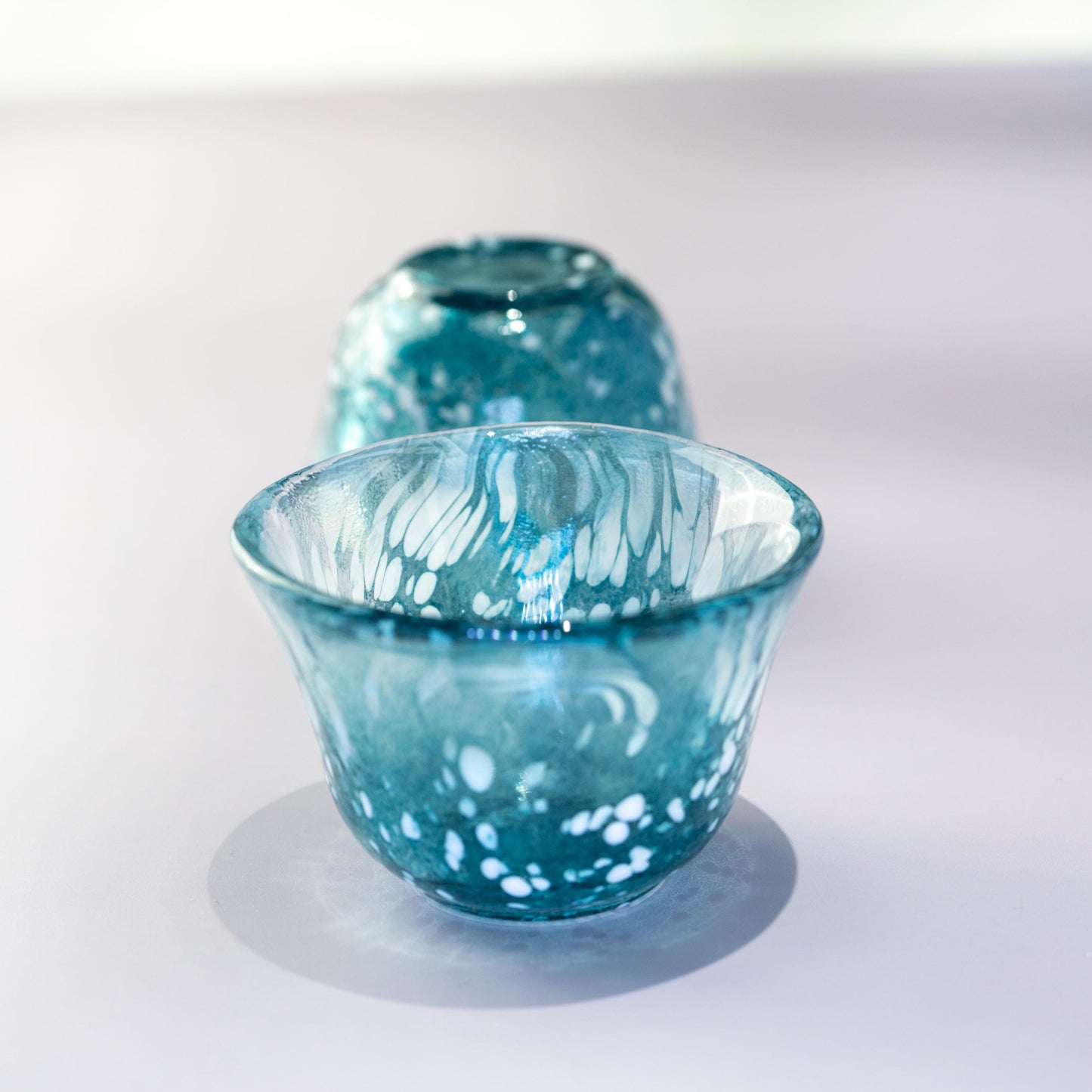 Close-up of blue sake cup in handmade Japanese glass