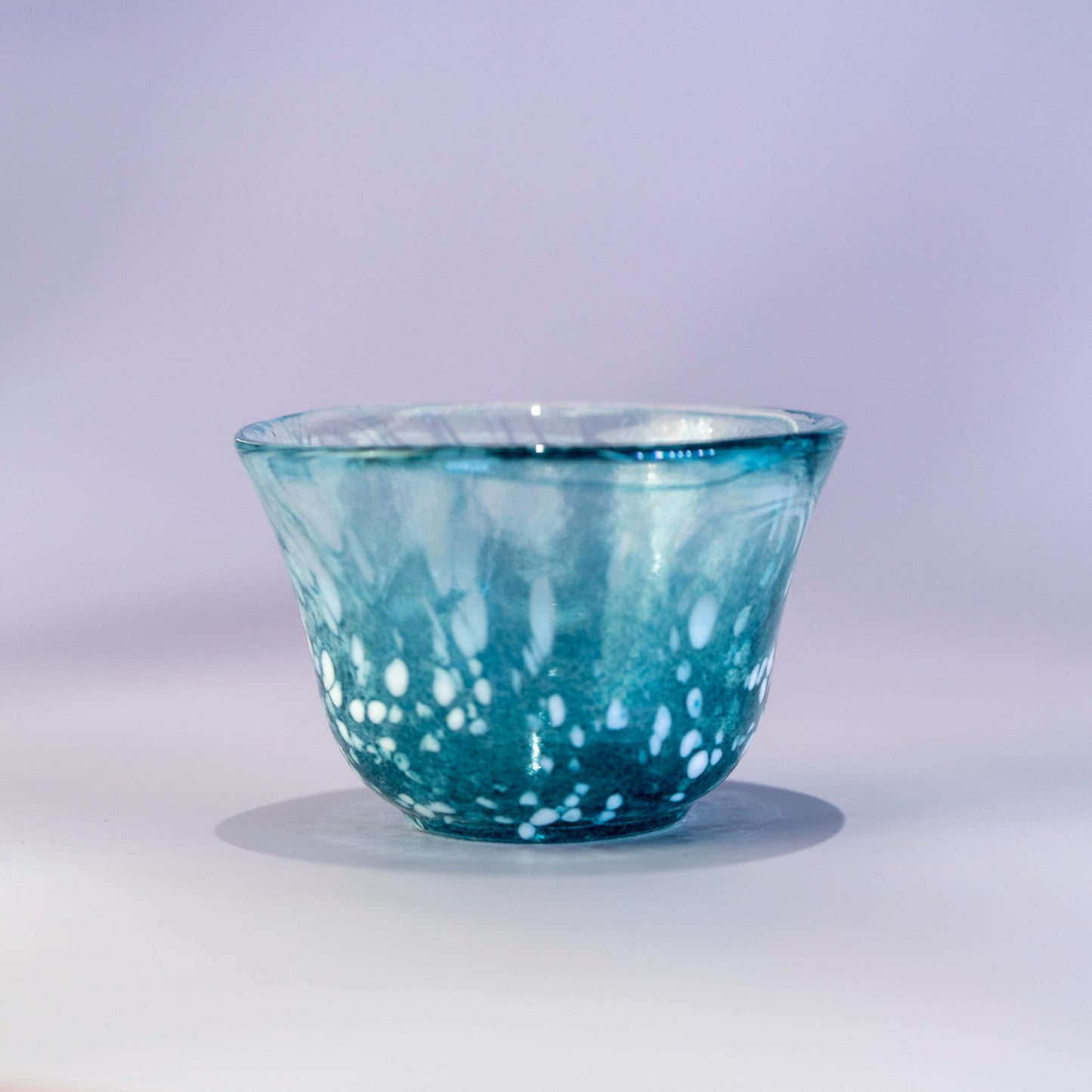 Close-up of blue sake cup in handmade Japanese glass