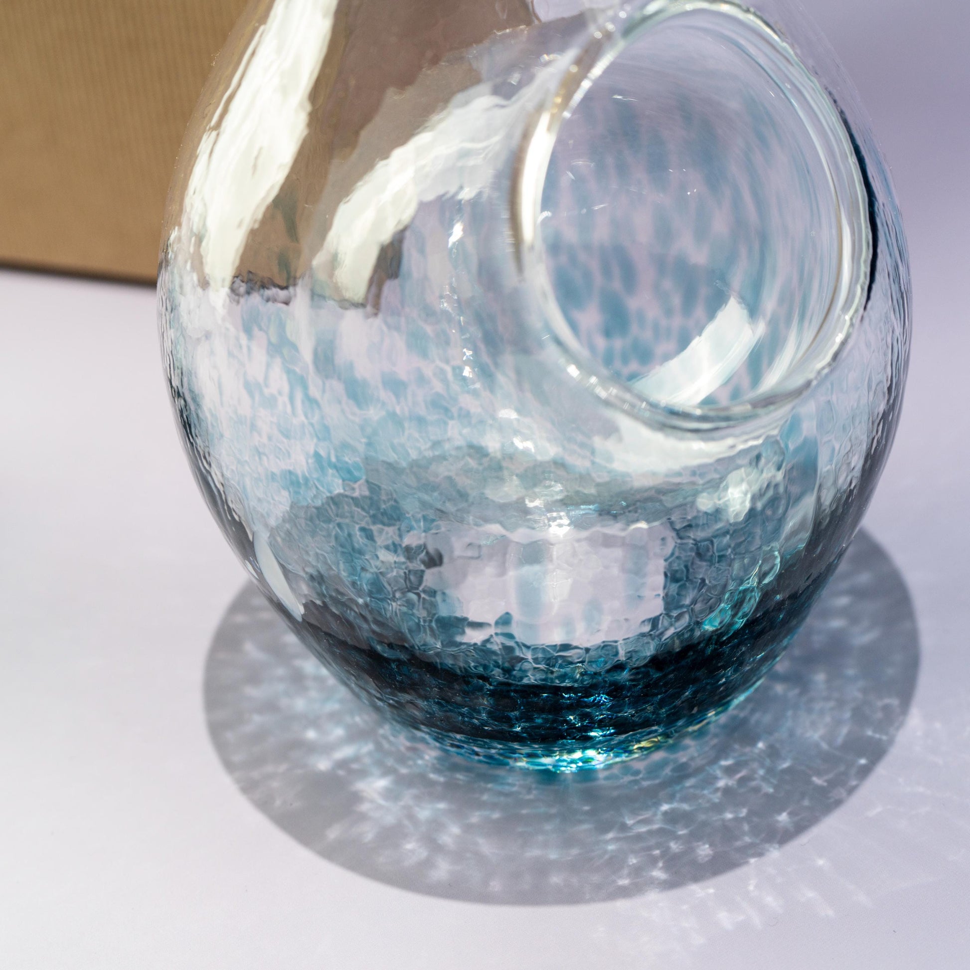 Side profile of blue glass carafe for chilled sake