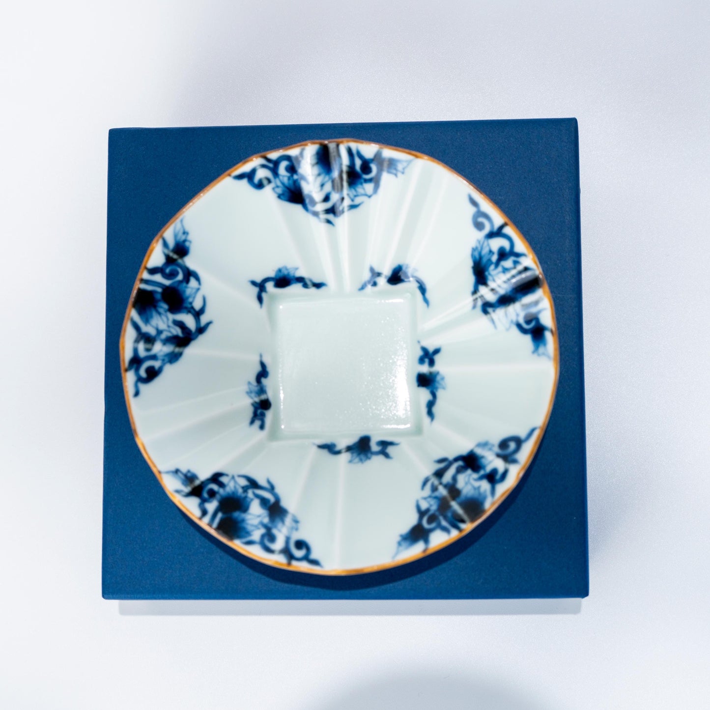 Top view of Arita ware porcelain bowl placed on a blue box