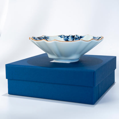 Arita ware blue arabesque bowl displayed on a blue presentation box