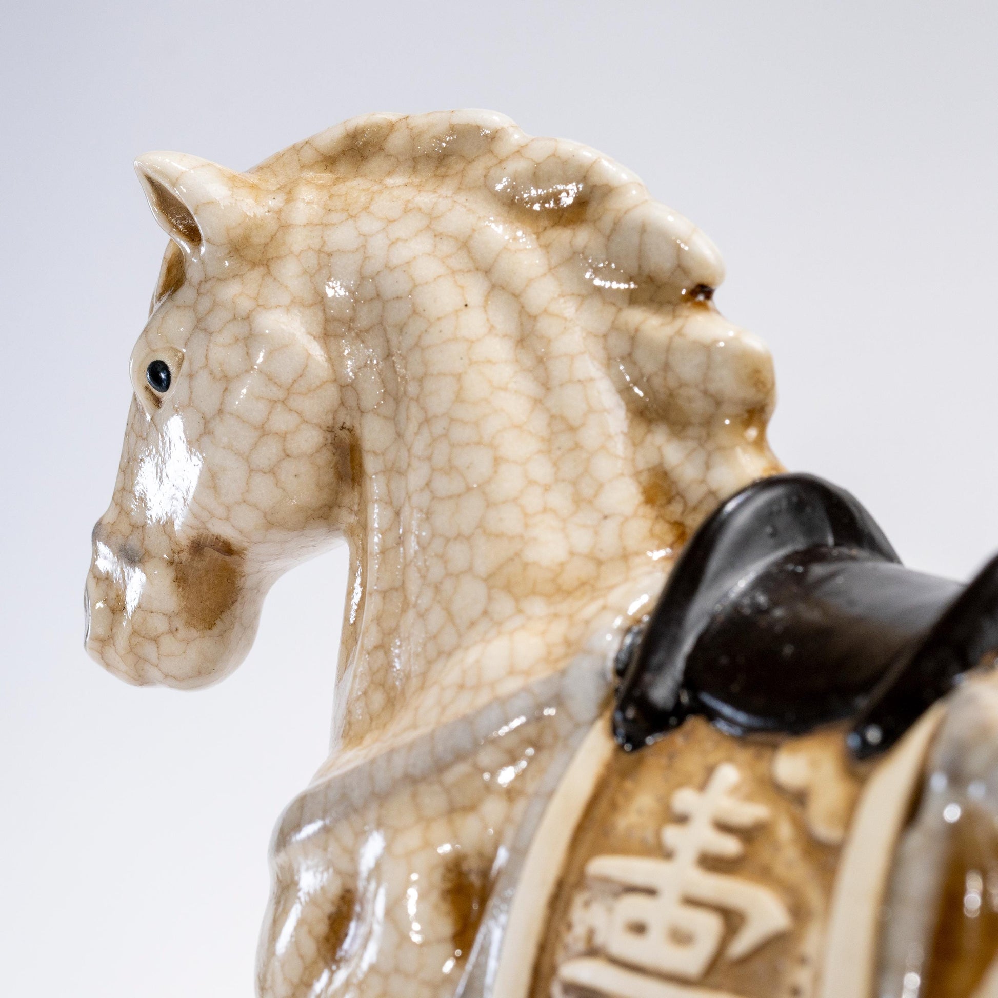 Close-up of the head and neck on a ceramic zodiac horse statue