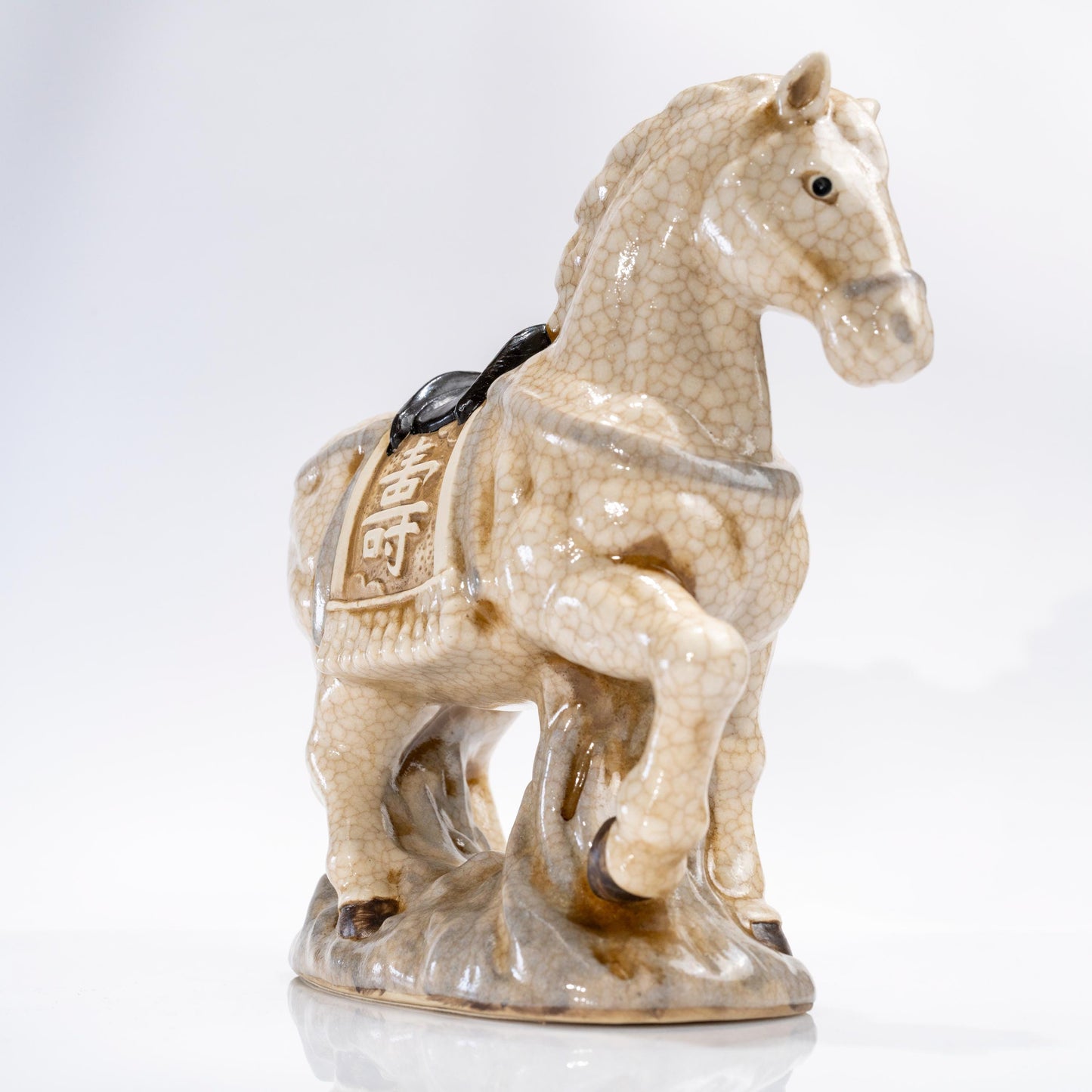 Three-quarter view of a ceramic lucky horse statue